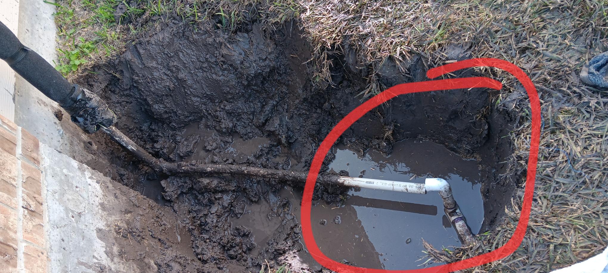 Broken water service pipe at the side of the house and underground